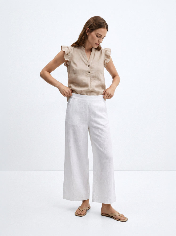 Blusa smanicata in lino con volant