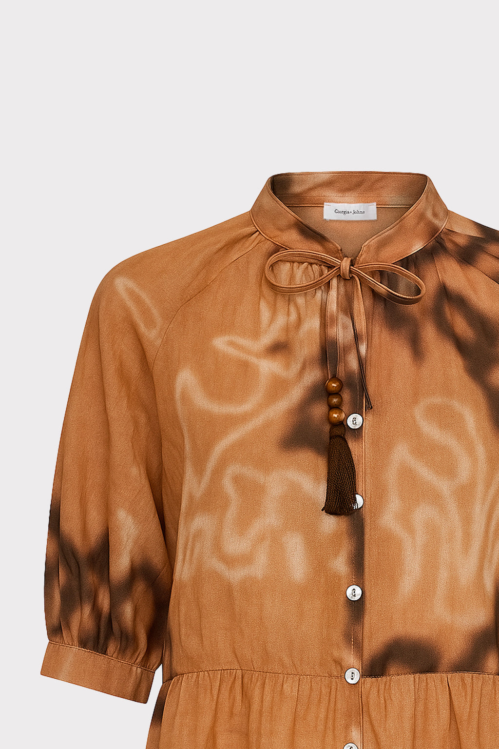 Blusa con laccio e nappine
